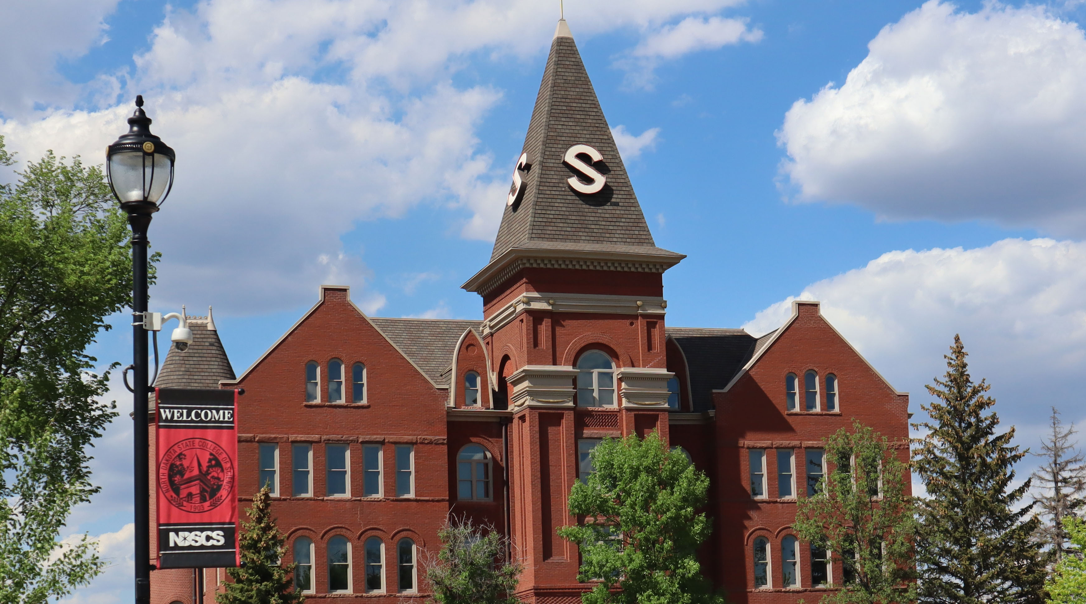 Old Main with welcome sign