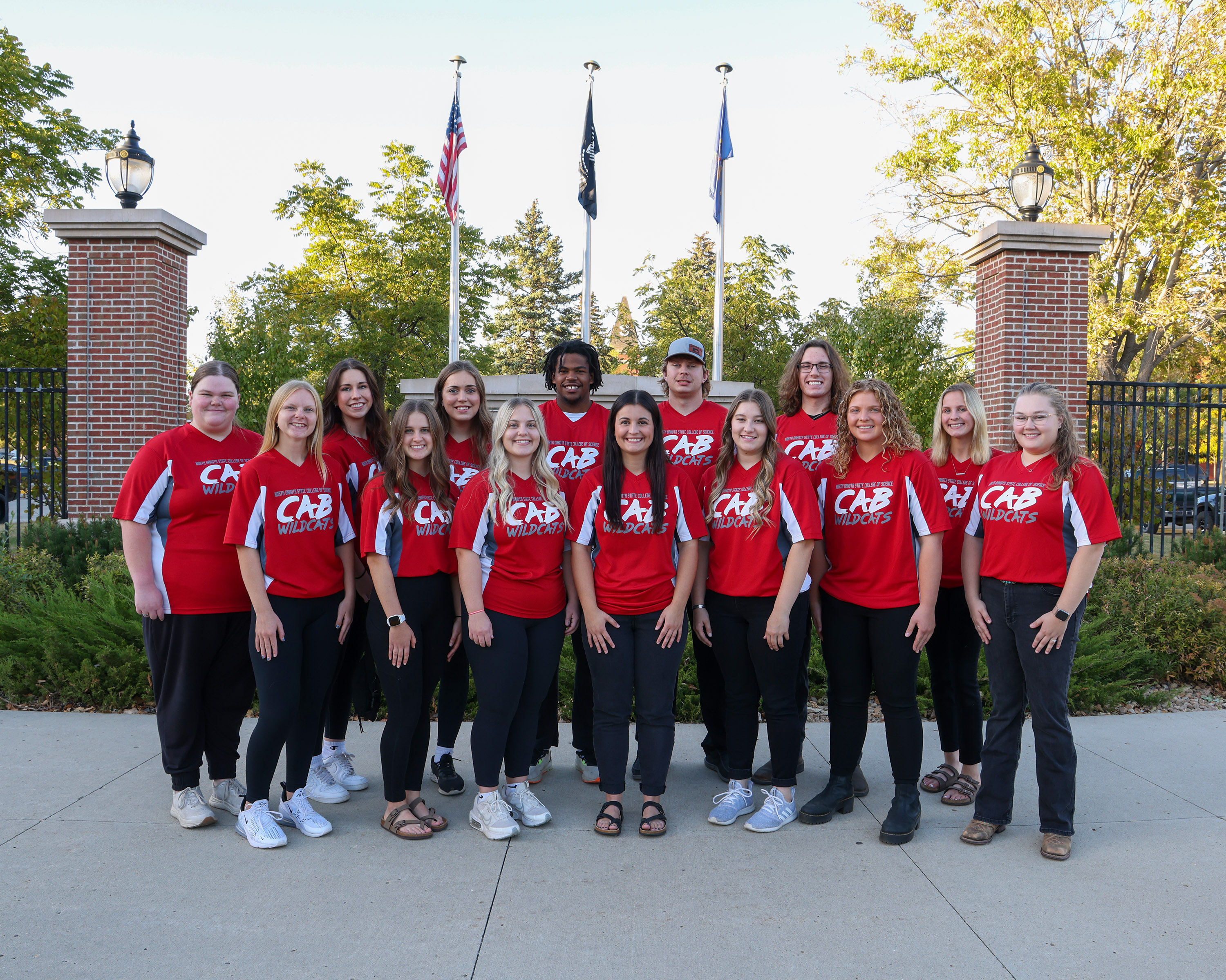 group of students standing in front of NDSCS sign