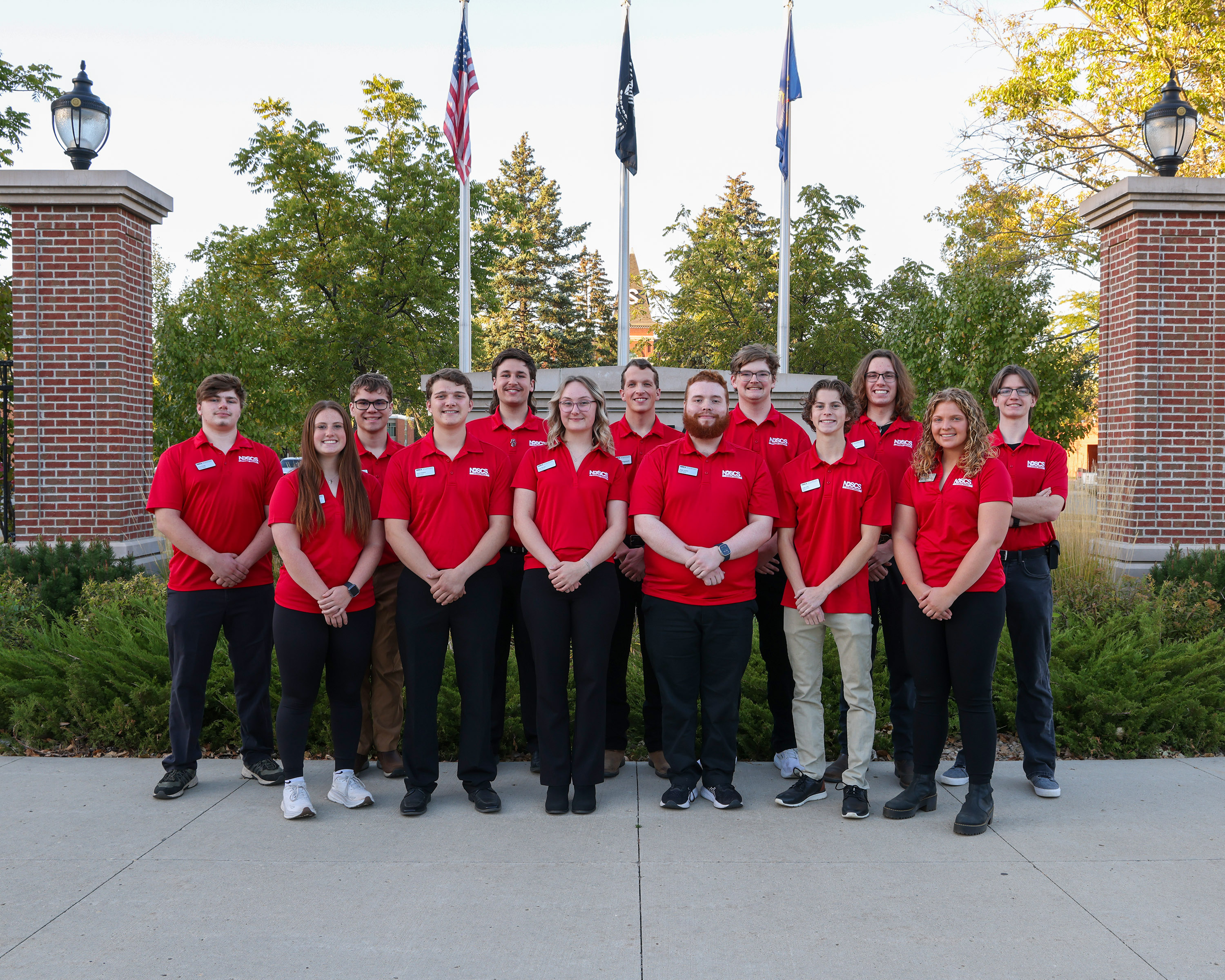 group of Student Senate students standing outside by a brick sign