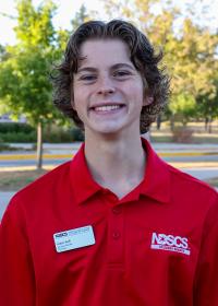 student in red shirt smiling