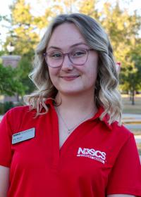 student in red shirt smiling