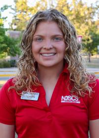 student in red shirt smiling