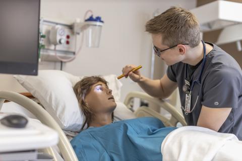 Nursing checking patient's eyes