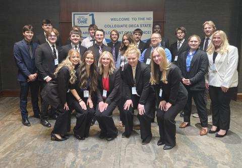 Group of college students standing together at a DECA competition