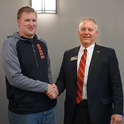 NDSCS President John Richman congratulates Alan Gilbertson